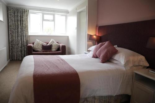 a bedroom with a large bed and a window at The Countryman’s Inn in Hunton