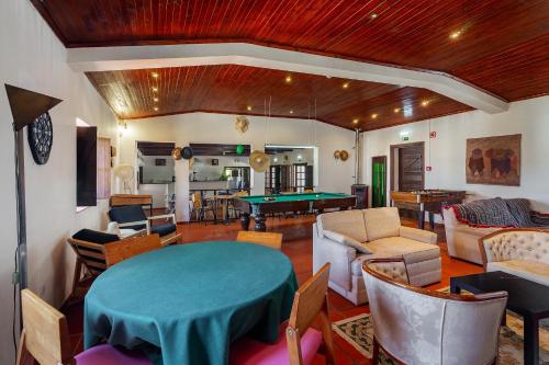 a living room with a table and a pool table at Chaparral Wonderful house in Nature 1h from Lisbon by Soulplaces in Silveiras