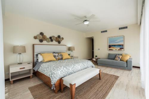 a bedroom with a bed and a couch at Luxury Beach Apartment at El Portillo - no extra fees in Las Terrenas