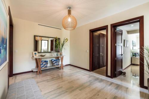 a hallway with a table and a mirror at 3BR apartment with balcony in Portillo - Terrenas in Las Terrenas