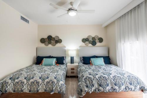 a bedroom with two beds and a ceiling fan at 3BR apartment with balcony in Portillo - Terrenas in Las Terrenas