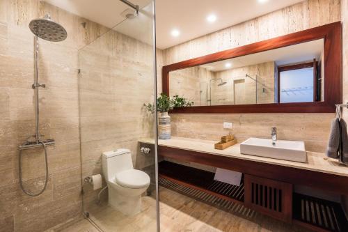 a bathroom with a toilet and a sink and a shower at 3BR apartment with balcony in Portillo - Terrenas in Las Terrenas