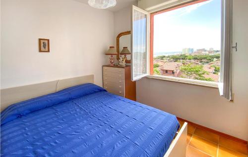 a bedroom with a blue bed and a large window at San Remo in Lido di Pomposa