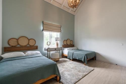 a bedroom with two beds and a window at Newly Added El Portillo 2BR Apt in Abra Grande