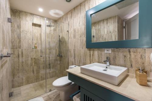 a bathroom with a sink and a glass shower at Newly Added El Portillo 2BR Apt in Abra Grande