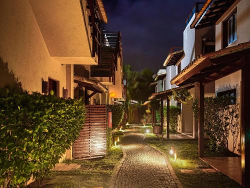 an alley between two buildings at night at A - Pipa Beleza Unidades Particulares in Pipa