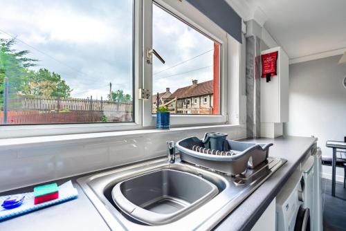 a kitchen with a sink and a window at Scotia House -3 bed house in Larkhall with private driveway in Larkhall