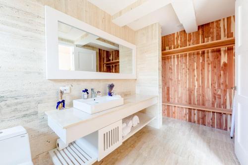 a bathroom with a sink and a mirror at classic but eccentric portillo 2BR apartment in Las Terrenas