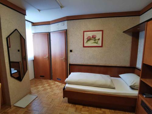 a bedroom with a bed and a mirror at Landrasthaus Maria Bild in Maria Bild