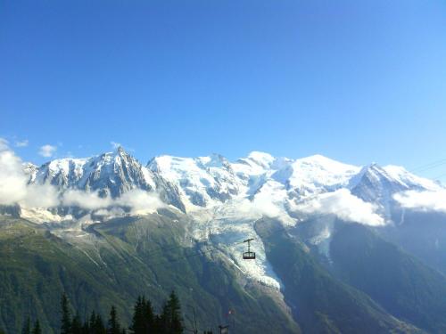 a ski lift in front of a snow covered mountain at Hotel Du Clocher in Chamonix-Mont-Blanc