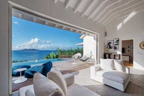 a living room with a view of the ocean at Infiniti Entire Luxury Villa Breath Taking View in St Barth in Pointe Milou