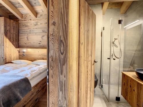 two pictures of a bedroom with a shower and a bed at Polaris 1 003 - LUXE & SKI LIFT apartment 6 pers in Zinal