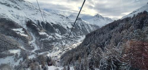 a ski lift flying over a snow covered mountain at Polaris 1 003 - LUXE & SKI LIFT apartment 6 pers in Zinal