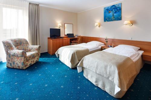 Postel nebo postele na pokoji v ubytování Hotel Wodnik