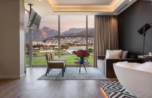 a living room with a couch and a large window at O' Two Hotel in Cape Town