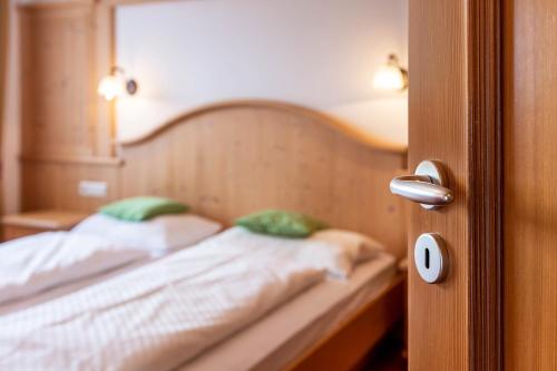 an open door to a bedroom with a bed at Residence Diana Apartment 103 in Terento