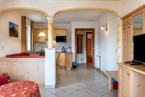 a kitchen and a living room with a counter at Residence Diana Apartment 103 in Terento