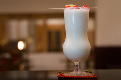 a drink with a cherry on top of a table at Pelyang Boutique in Thimphu