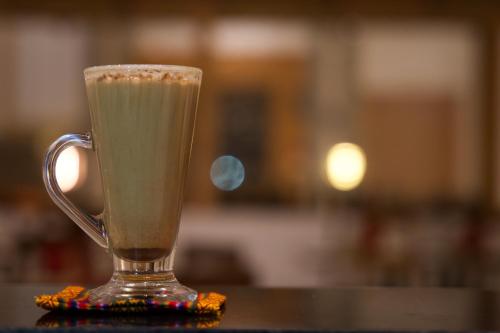 a glass mug of coffee sitting on a table at Pelyang Boutique in Thimphu