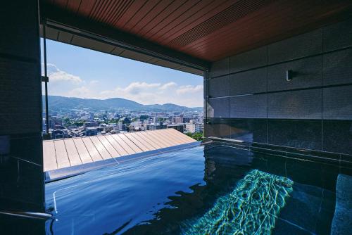 a swimming pool on the side of a building at Sora Niwa Terrace Kyoto in Kyoto