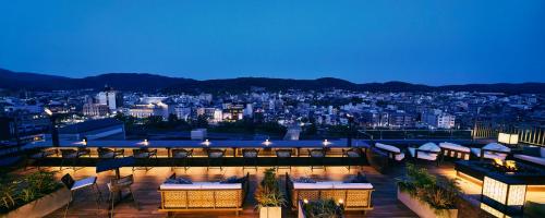 a view of a city skyline at night at Sora Niwa Terrace Kyoto in Kyoto