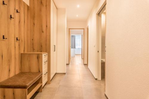 a hallway with wooden walls and a bench in a bathroom at Residence Diana Apartment 402 in Terento