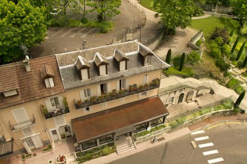 an overhead view of a building with flowers on the windows at Hôtel de la Grotte in Aix-les-Bains