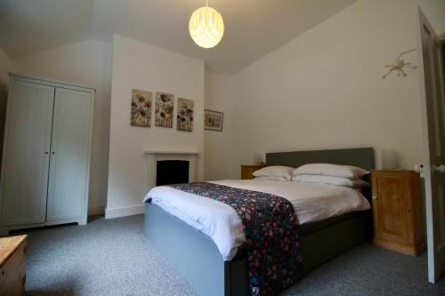 a bedroom with a bed and a fireplace at Blachington Cottage, Stunning and Central By Air Premier in Seaford