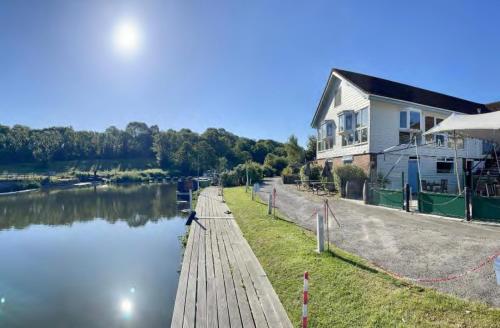 a house with a dock next to a river at The Riverside inn in Saltford