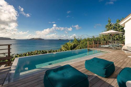 a swimming pool with a view of the ocean at Infiniti 2 BR Private Luxury Villa Breath Taking View in St Barth in Pointe Milou