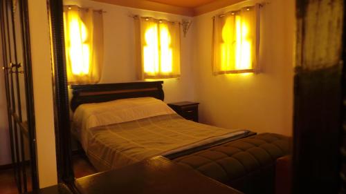 a small bedroom with a bed and a mirror at Targafit Hotel & Hammam in Marrakech