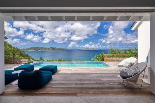 a swimming pool with a view of the ocean at Infiniti 1 BR Private Luxury Villa Breath Taking View in St Barth in Pointe Milou