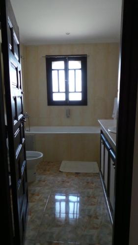 a bathroom with a sink and a toilet and a window at Targafit Hotel & Hammam in Marrakech