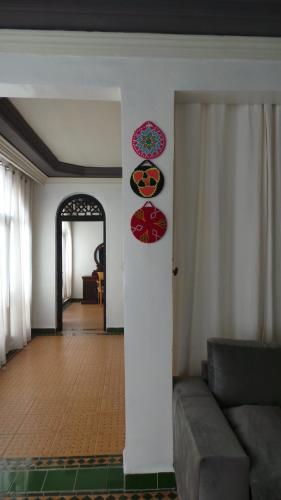 a living room with a couch and posters on a wall at Targafit Hotel & Hammam in Marrakech