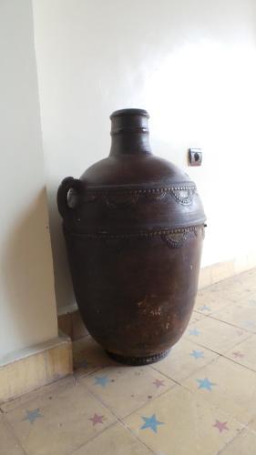 a large brown vase sitting on a tile floor at Targafit Hotel & Hammam in Marrakech