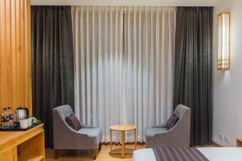 two chairs and a table in a hotel room at Pelyang Boutique in Thimphu