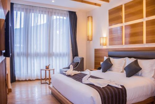 a bedroom with a large bed with swans on it at Pelyang Boutique in Thimphu