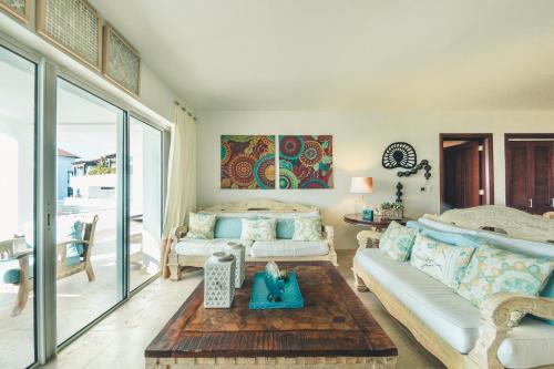 a living room with a couch and a table at Punta Palmera Beachfront Apartment in Punta Cana