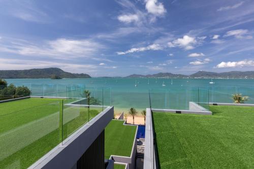 a view of the water from the balcony of a house at X10 Seaview Suites at Panwa Beach in Panwa Beach