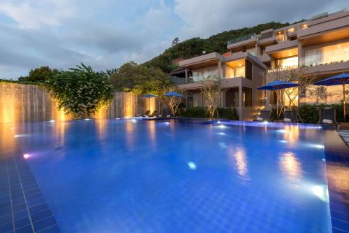 a large swimming pool in front of a building at X10 Seaview Suites at Panwa Beach in Panwa Beach