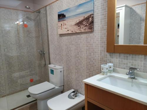 a bathroom with a toilet and a sink and a shower at Casa Bubal by Best Holidays Fuerteventura in Corralejo
