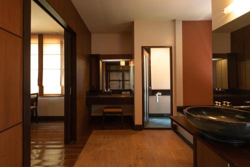 a bathroom with a sink and a mirror at Kireethara Boutique Resort in Chiang Mai