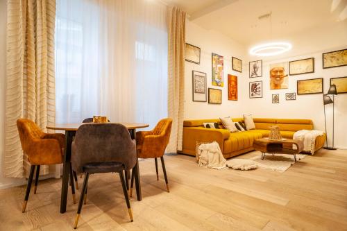 a living room with a table and a yellow couch at Sting Old Town Ostrava in Ostrava