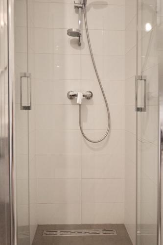 a shower with a shower head in a bathroom at Guest House Marija in Bol