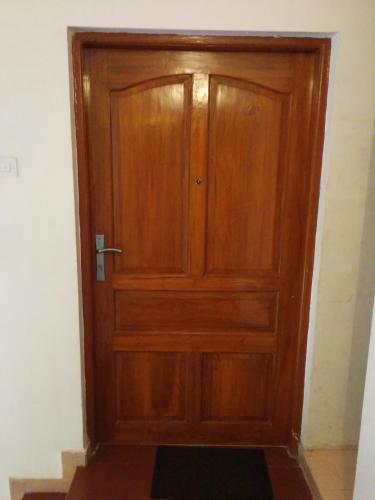 a wooden door in the corner of a room at Antonio's Residency Goa in Betalbatim