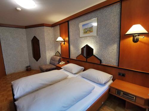a bedroom with a large white bed in a room at Landrasthaus Maria Bild in Maria Bild