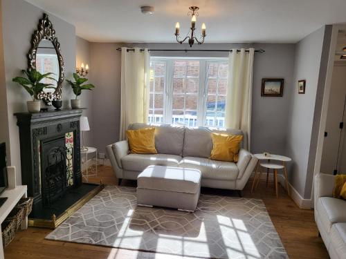 a living room with a couch and a fireplace at Pebble Cottage in Worthing