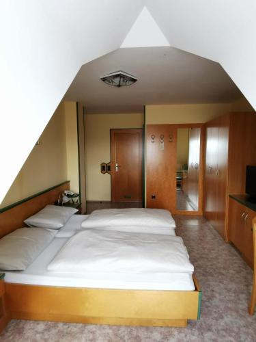 a bedroom with a large bed in an attic at Landrasthaus Maria Bild in Maria Bild