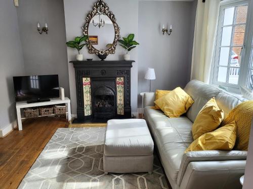 a living room with a couch and a fireplace at Pebble Cottage in Worthing