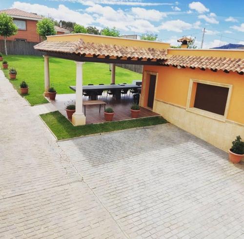 a house with a patio with a picnic table at El cerro de cabañeros in Retuerta de Bullaque